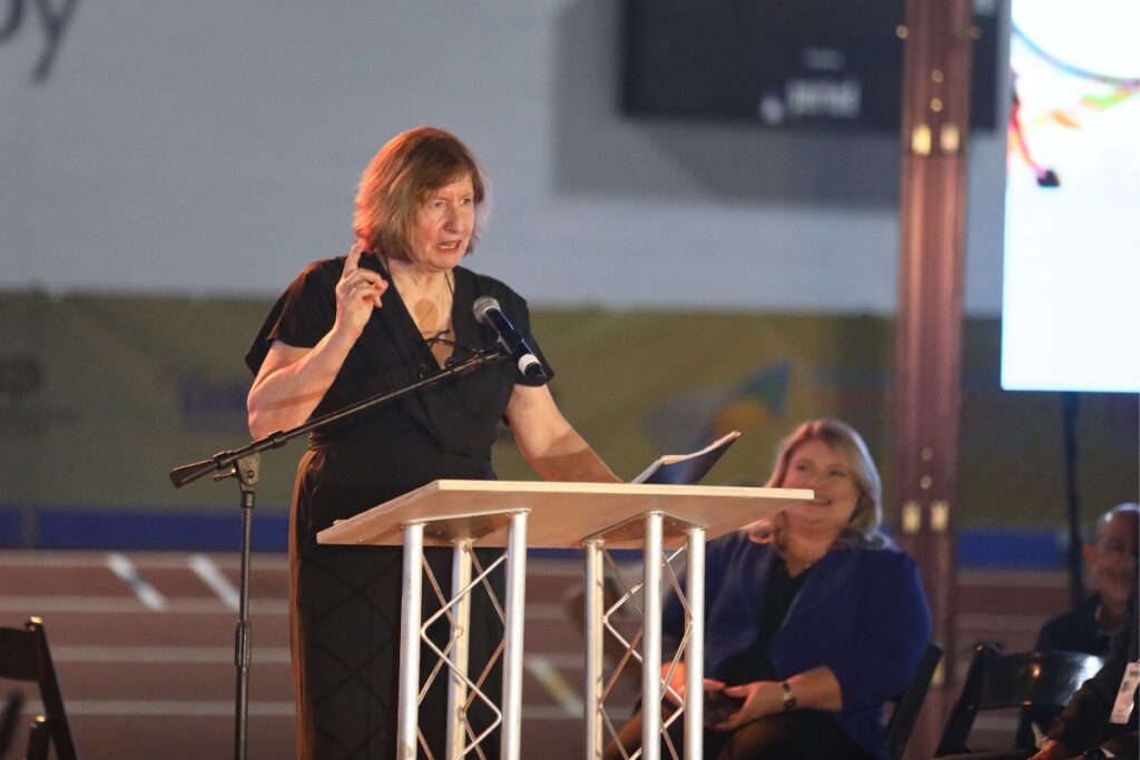 Margit Jungmann, president of the World Masters Athletics Council, speaks at the opening ceremony.