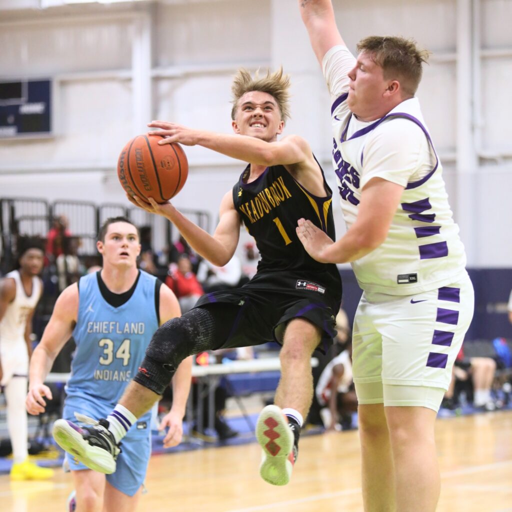 Meadowbrook Academy's Beau Suarez (1) puts up a shot against Gainesville's Aidan Bell (33) at The Prep Zone All-Star Showcase. Photo by C.J. Gish