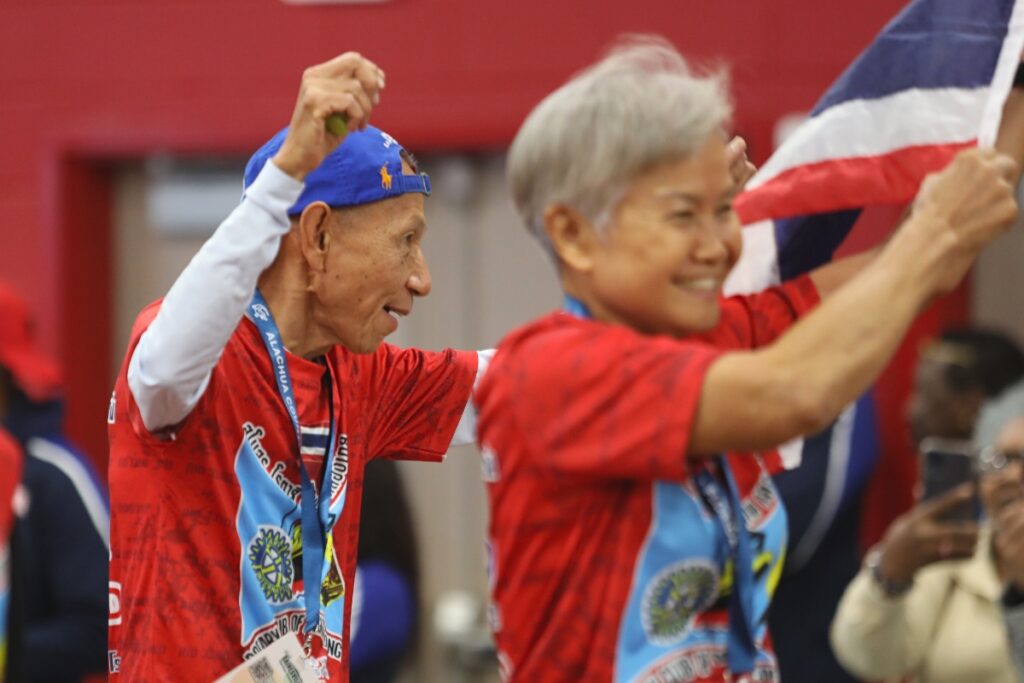 Members of Team Thailand wave to the crowd during the Parade of Nations. 