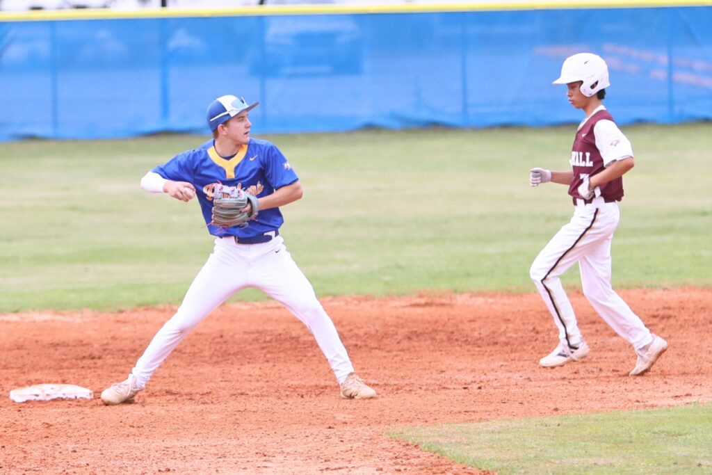 Newberry's Brody Joyner gets Oak Hall's Bo Kuzmicki (7) out at second base and attempts a double play in the top of the third inning. Photo by C.J. Gish