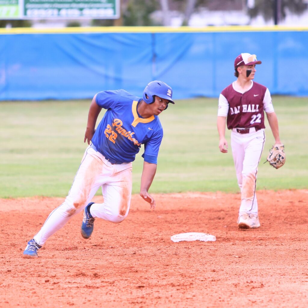 Newberry's Tavis Honeycutt (22) rounds second base on a third-inning steal against Oak Hall. Photo by C.J. Gish