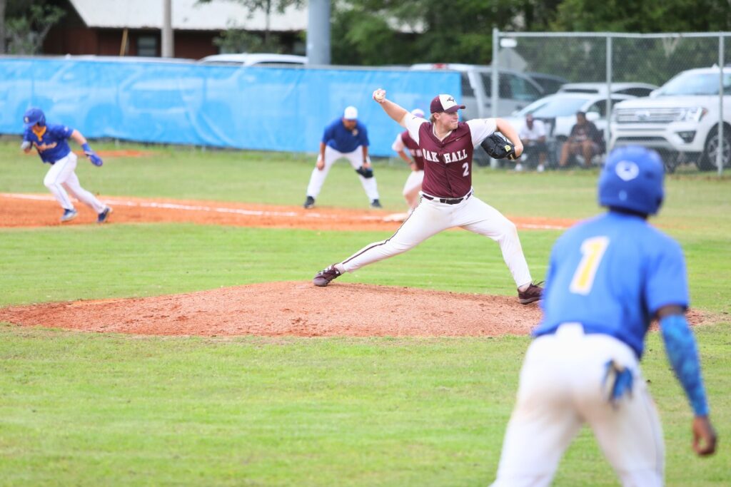 Oak Hall's Gavin Jones with a third-inning pitch with runners on first and third against Newberry. Photo by C.J. Gish