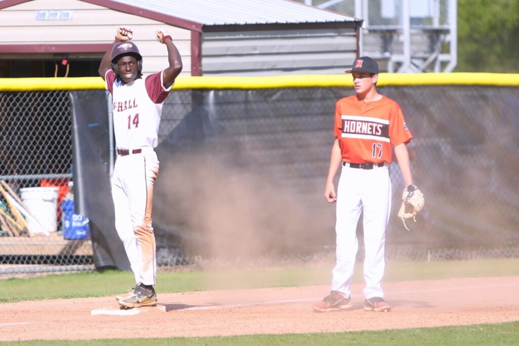 Oak Hall's Kingston Mosley celebrates after hitting a triple in the second inning against Hawthorne. Photo by C.J. Gish