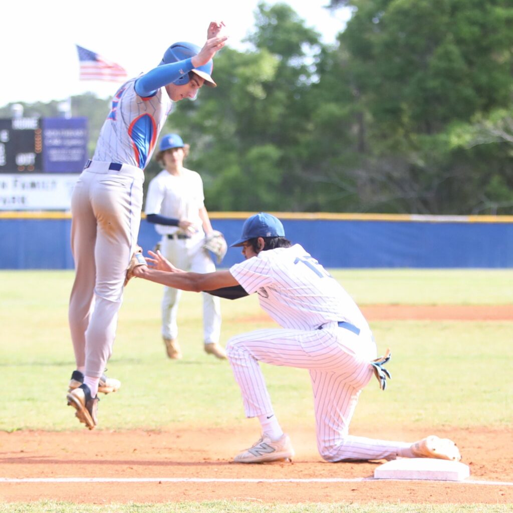 P.K. Yonge's Micah Gratto gets tagged out in the second inning trying to steal third base by St. Francis Catholic's Colin Kuruppacherry. Photo by C.J. Gish