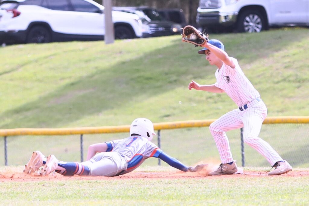 P.K. Yonge's Tyler Belleville beats the throw to St. Francis Catholic's Cyrus Fariborzian at first base. Photo by C.J. Gish