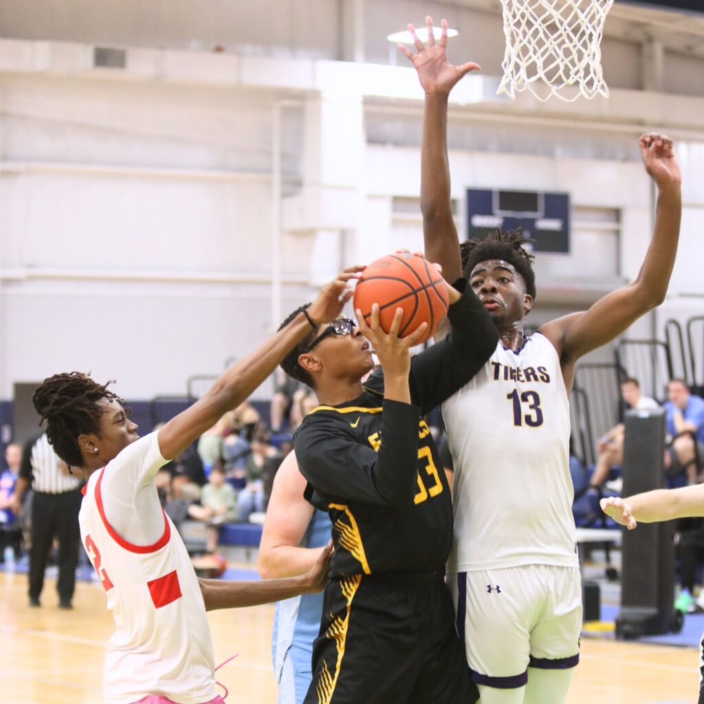 Santa Fe's Cedric Collins (2) and Columbia's Zavian Douglas (12) attempt to block a shot by First Assembly Christian's Sean James (33) at The Prep Zone All-Star Showcase. Photo by C.J. Gish