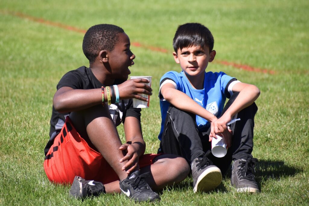 Students chat on the sidelines while they wait for their event. Photo by Glory Reitz