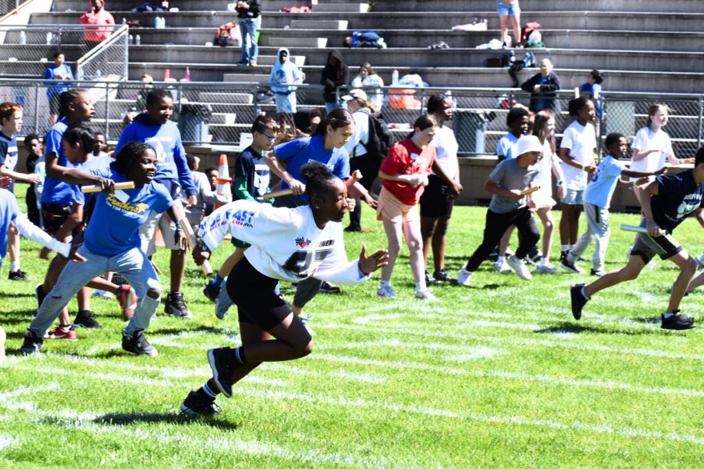Students run in a relay race. Photo by Glory Reitz