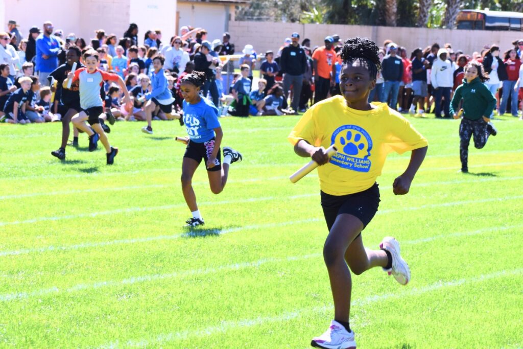 Students run in the baton relay. Photo by Glory Reitz