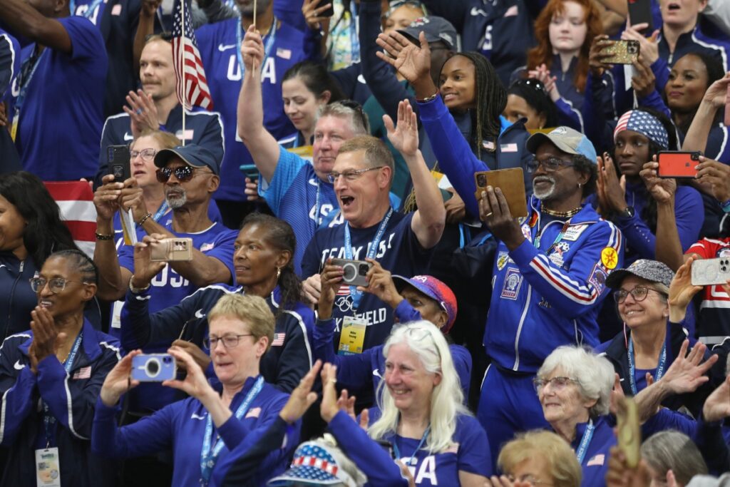 Team USA members cheer in the stands while the Stars and Stripes comes past during the Parade of Nations. 