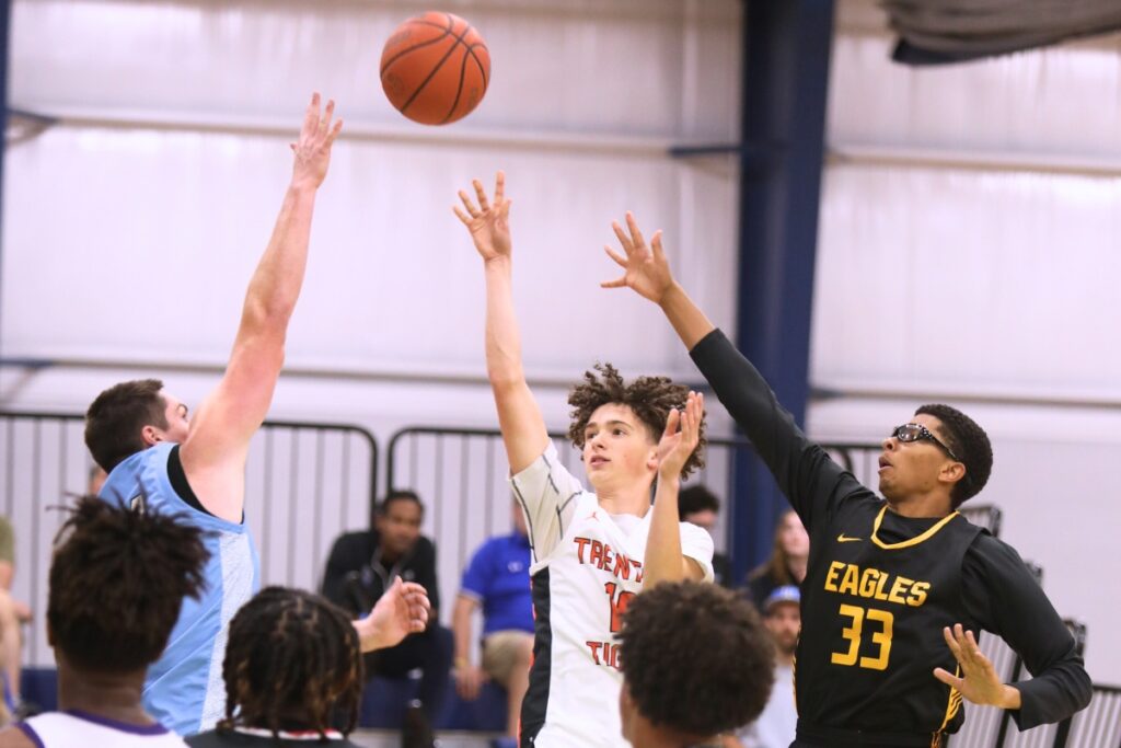 Trenton's Clark Hausner puts up a shot against Chiefland's Mike Goodale and First Assembly Christian's Sean James (33) at The Prep Zone All-Star Showcase. Photo by C.J. Gish