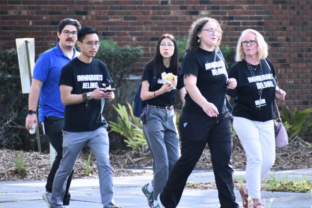 A group of community members walk to the school board meeting to demand stronger ICE policies. Photo by Glory Reitz