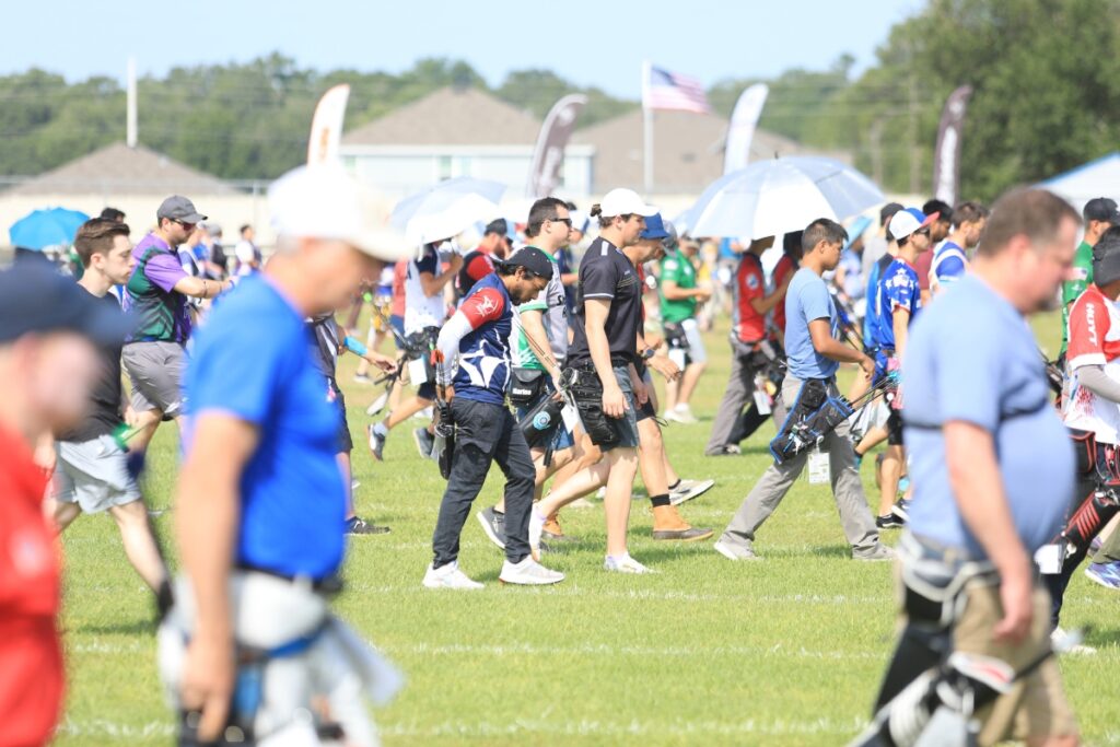 The entire field of archers heads to their targets to check scores. 