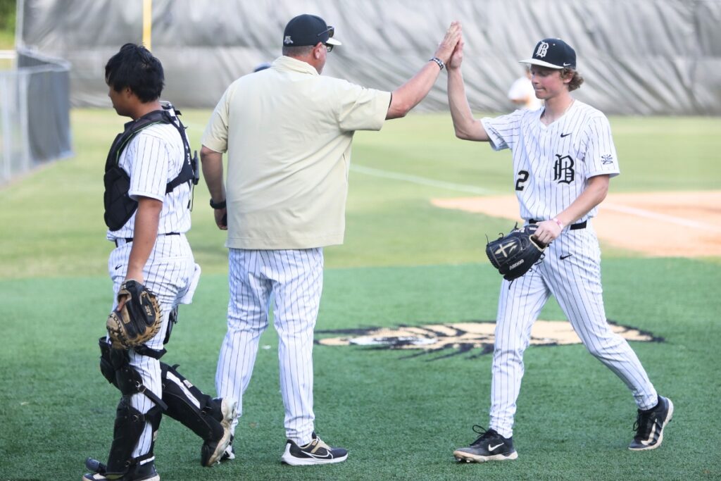 Buchholz head coach Ron Brooks high fives pitcher Aidan Kastensmidt after the top of the third inning against Colquitt County. Photo by C.J. Gish