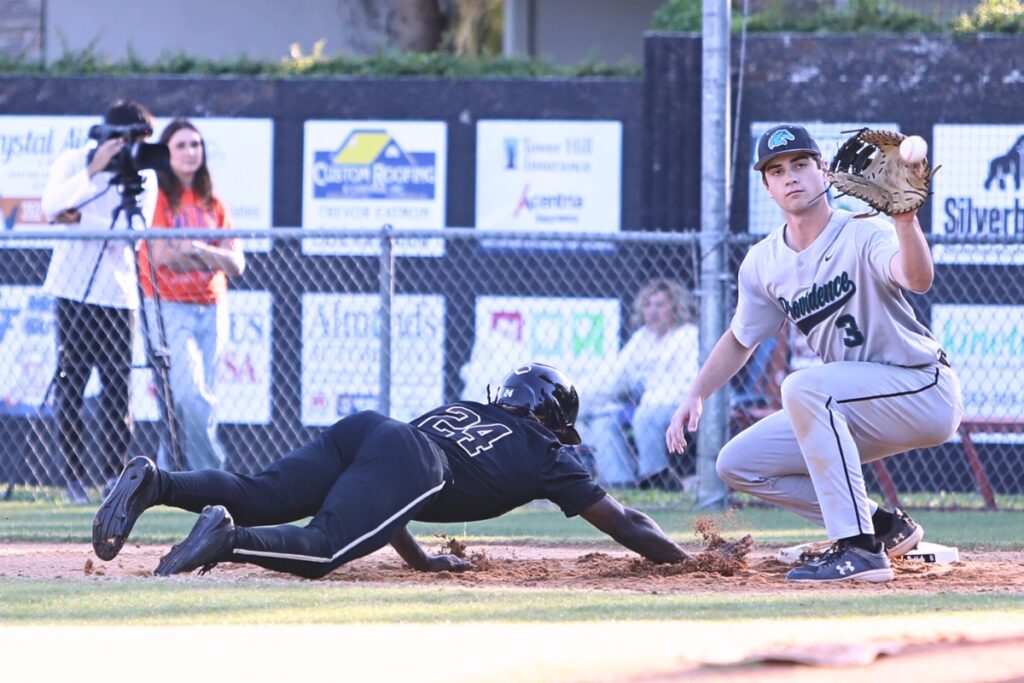 Buchholz's EJ Williams (24) dives safely back to first base in the bottom of the second inning against Providence (Jacksonville). Photo by C.J. Gish