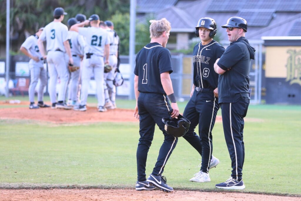 Buchholz's Hudson Sapp (1) and Drew Almond (8) talk with third base Chris Malphurs during a Providence (Jacksonville) pitching timeout in the bottom of the fourth inning. Photo by C.J. Gish 1