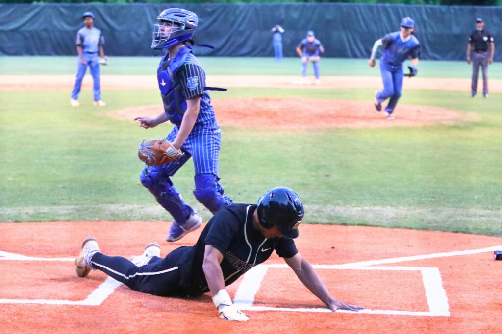 Buchholz's Justin Williams slides across home plate in the fifth inning against First Coast (Jacksonville) in game two of the 6A Region 1 Quarterfinals. Photo by C.J. Gish