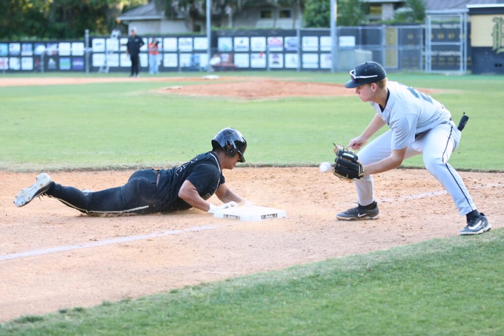 Buchholz's Stuart Ding slides safely into third base in the bottom of the fourth inning against Providence (Jacksonville). Photo by C.J. Gish