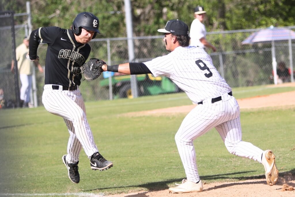 Buchholz's Wyatt Clarke (9) tags the Colquitt County runner out at first base for the third out in the top of the first inning. Photo by C.J. Gish