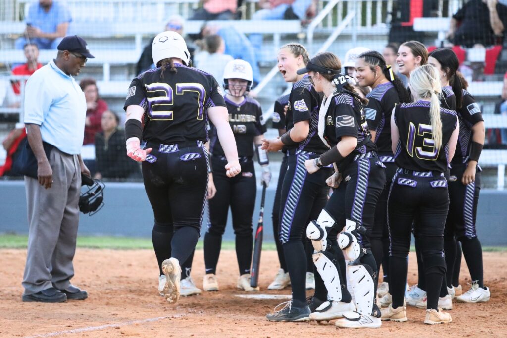 Columbia's Josie Raulerson (27) is greeted by her teammates at home plate after hitting a two-run home run in the bottom of the third inning. Photo by C.J. Gish 1 (1)