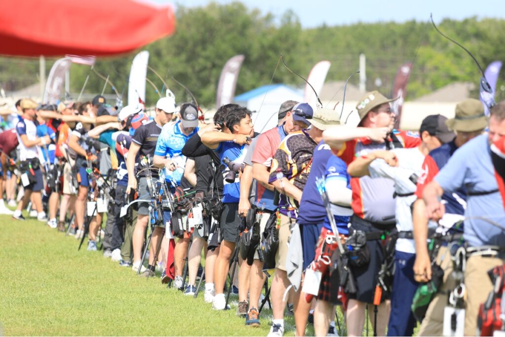 Contestants line up side by side to shoot during qualifying. 