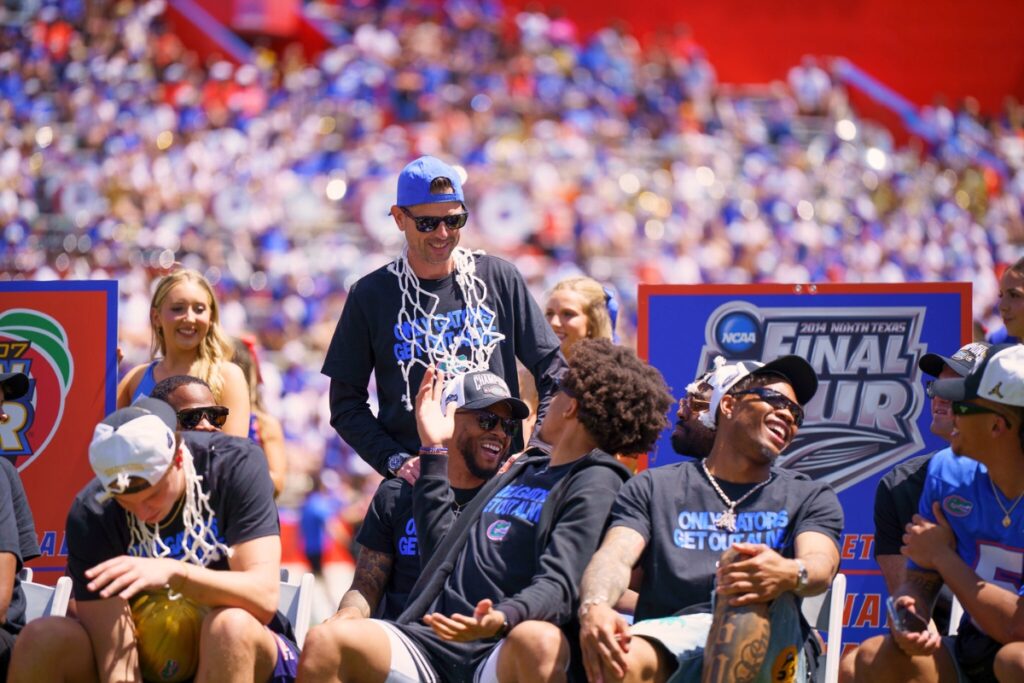 Florida men's basketball coach Todd Golden (standing) talks to player during halftime at the Orange and Blue spring football game. Photo by Tim Rodriquez