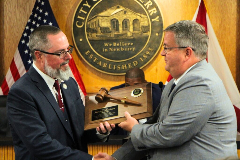 Former Newberry mayor and new city manager Jordan Marlowe (left) received a plaque from new Mayor Tim Marden honoring his city service. Photo by Lillian Hamman