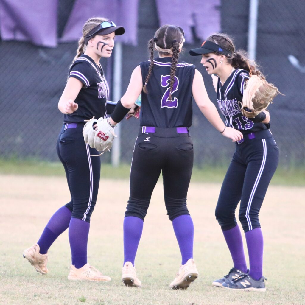 (From left) Gainesville outfielders Emma Barton (3), Olivia Lockerman (2) and Josie Kirwan (13) get ready for the fourth inning against Belleview in the 5A District 5 Semifinals. Photo by C.J. Gis