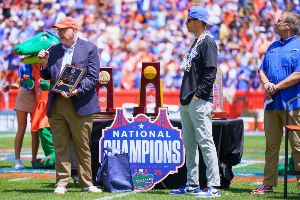 Gainesville Mayor Harvey Ward presents the key to the city to Florida men's basketball coach Todd Golden. Photo by Tim Rodriquez