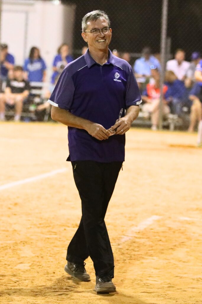 Gainesville coach Chris Chronister cracks a smile in the sixth inning after the Hurricanes go up 5-1 against Belleview in the 5A District 5 Semifinals. Photo by C.J. Gish