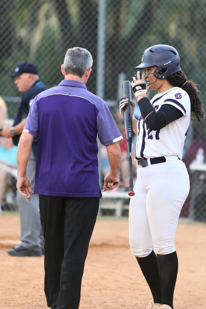 Gainesville coach Chris Chronister talks things over with Braylin Cook (27) against Santa Fe. Photo by C.J. Gish
