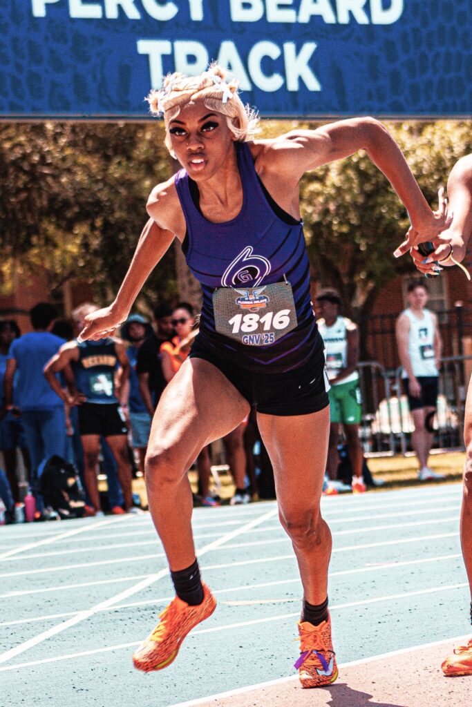 Gainesville's Aaliyha McClellon takes a handoff in the 4x100-meter relay at the UF Pepsi Florida Relays on Saturday. Photo by Ahnaf Rashid