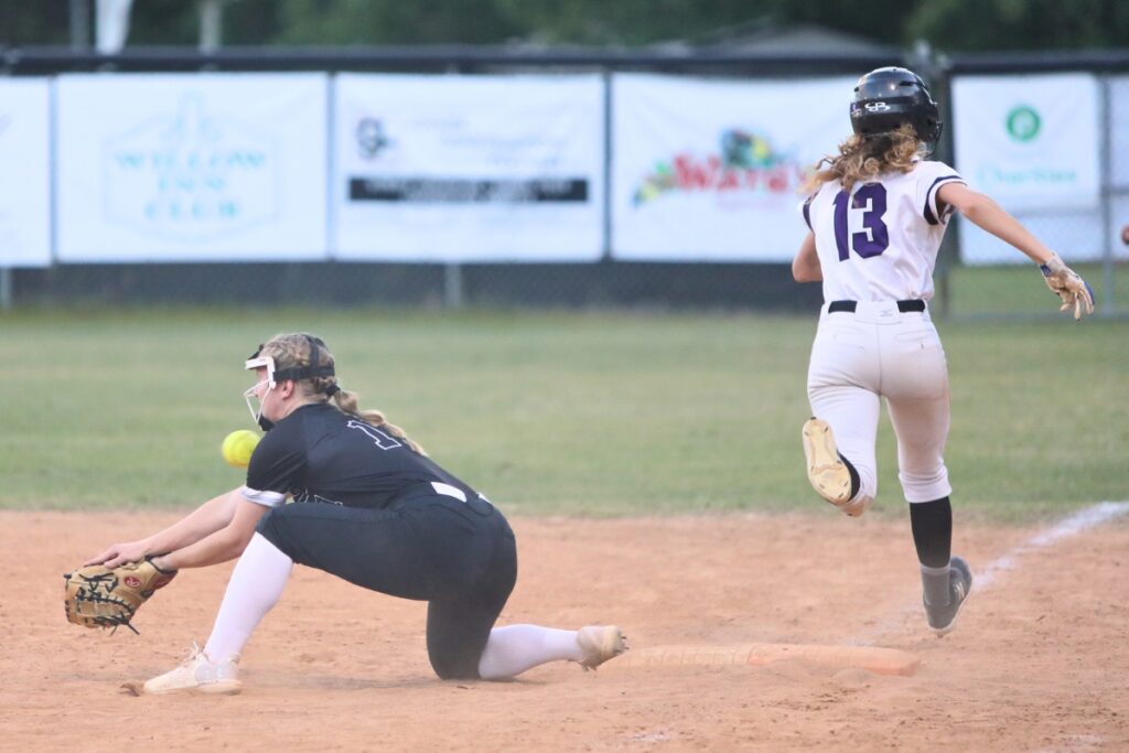 Gainesville's Josie Kirwan (13) outruns the throw to first base in the second inning against Santa Fe. Photo by C.J. Gish