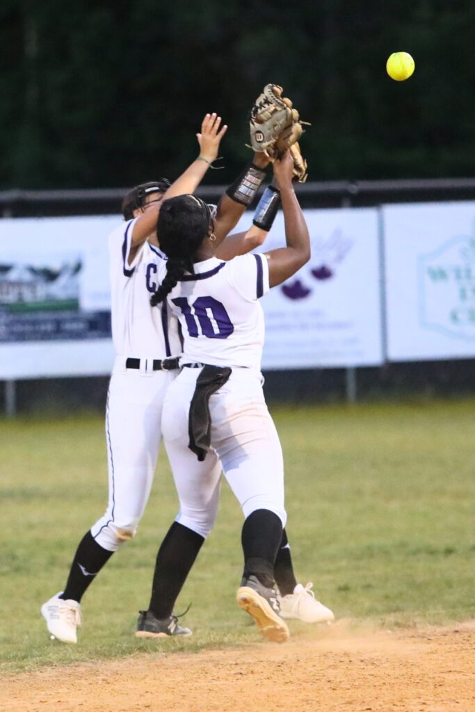 Gainesville's Lana Renicks (15) and Madisyn Gillins (10) collide after going for a pop-up in the fourth inning against Santa Fe. Photo by C.J. Gish