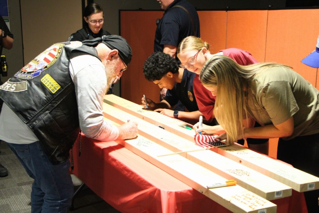 HTOF celebration attendees sign studs to be installed in the Rivera's home. Photo by Lillian Hamman