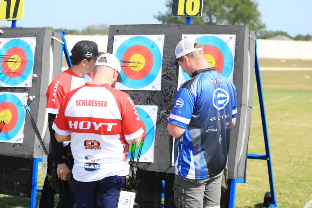 Mike Schloesser tracks his score during the qualifying round, where he tied the world record for compound men. 