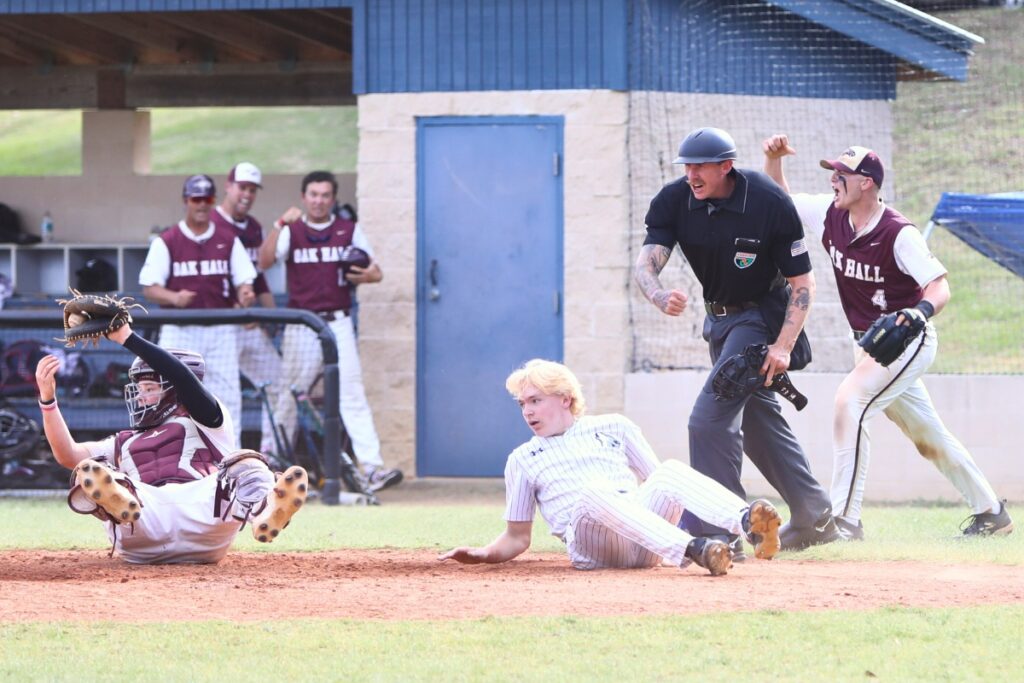 Oak Hall catcher Cameron Currier tags St. Francis Catholic's Sander Williams (17) out in the fourth inning of game two in the 1A Regional quarterfinals. Photo by C.J. Gish