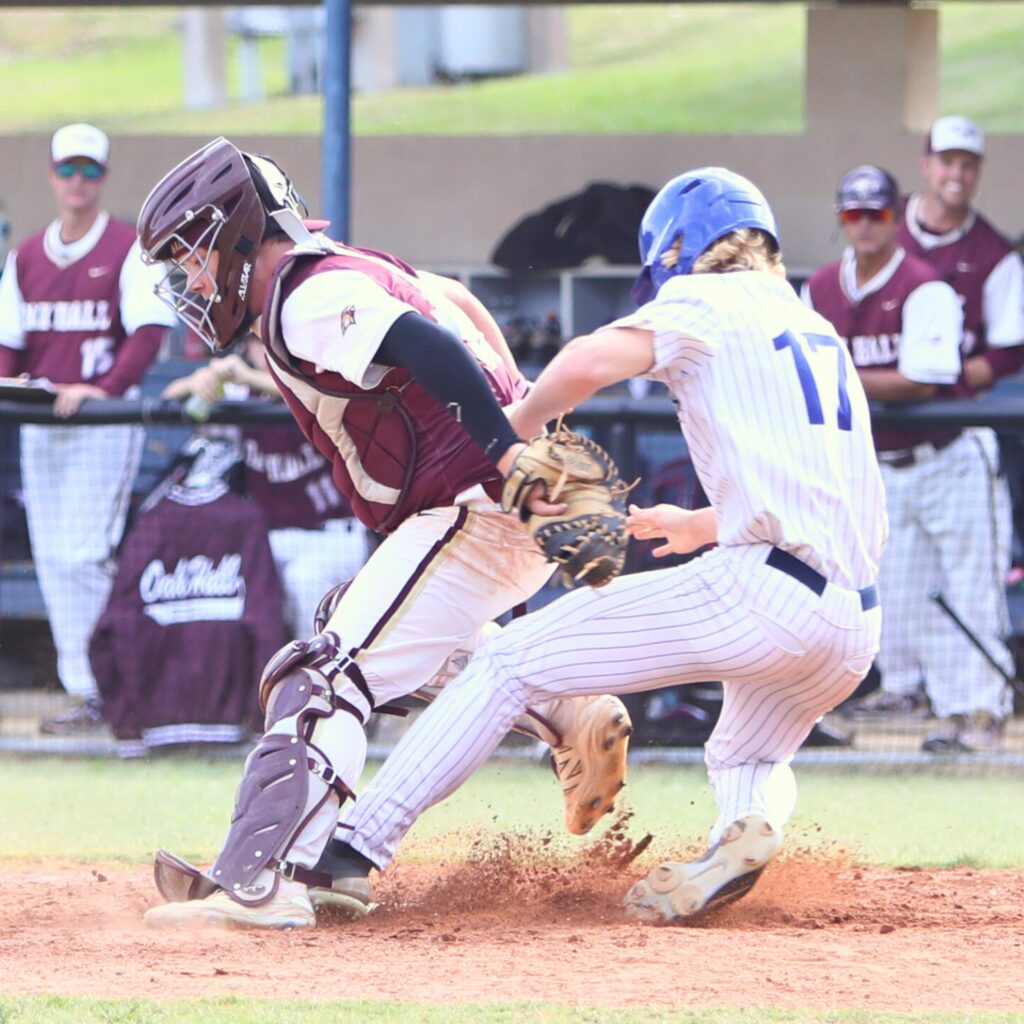 Oak Hall catcher Cameron Currier tags St. Francis Catholic's Sander Williams out in the fourth inning of game two in the 1A Regional quarterfinals. Photo by C.J. Gish