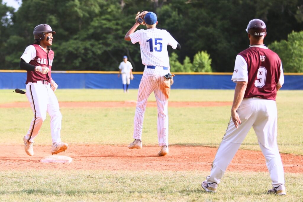 Oak Hall's Aaron Akins hits a triple to start the seventh inning against St. Francis Catholic in game two of the 1A Regional quarterfinals. Photo by .J. Gish 1