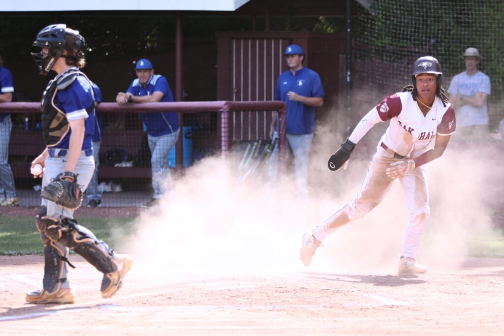 Oak Hall's Aaron Akins scores the first run in the first inning against St. Francis Catholic in game three of the 1A Region 2 Quarterfinals. Photo by C.J. Gish