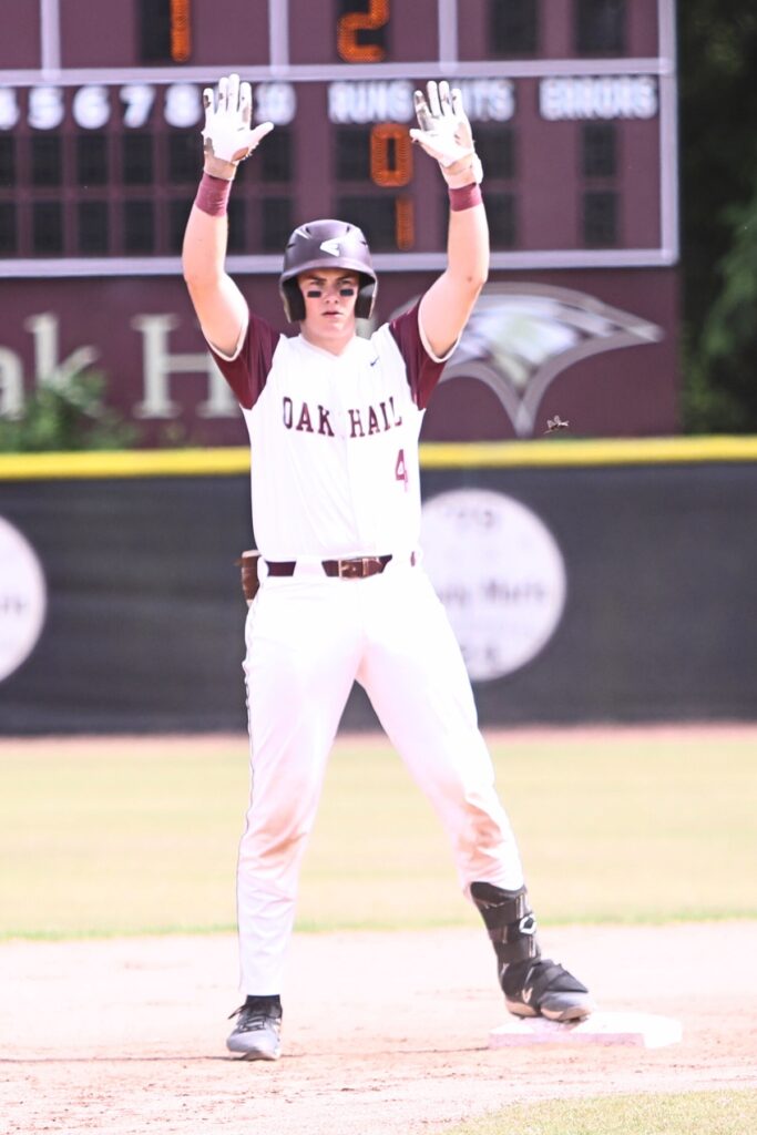 Oak Hall's Brody Beaupre (4) celebrates his first inning one-run double against St. Francis Catholic in game three of the 1A Region 2 Quarterfinals. Photo by C.J. Gish