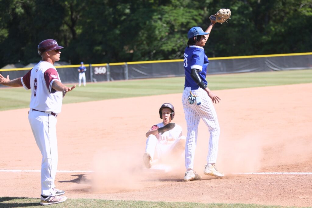 Oak Hall's Lincoln Jones gets tagged out at third base by St. Francis Catholic's Colin Kuruppacherry in the second inning of the Class 1A-District 5 championship game. Photo by C.J. Gish