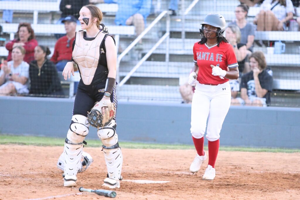Santa Fe's J’lyn Guyden (right) put the Raiders on the board with their first run in the top of the third inning against Columbia. Photo by C.J. Gish