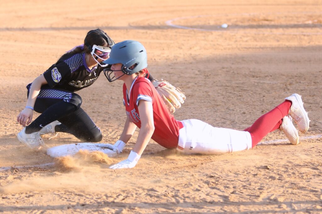 Santa Fe's Maren Hornsby dives back safely to third base under the tag of Columbia's Lillyenne Mayhew. Photo by C.J. Gish