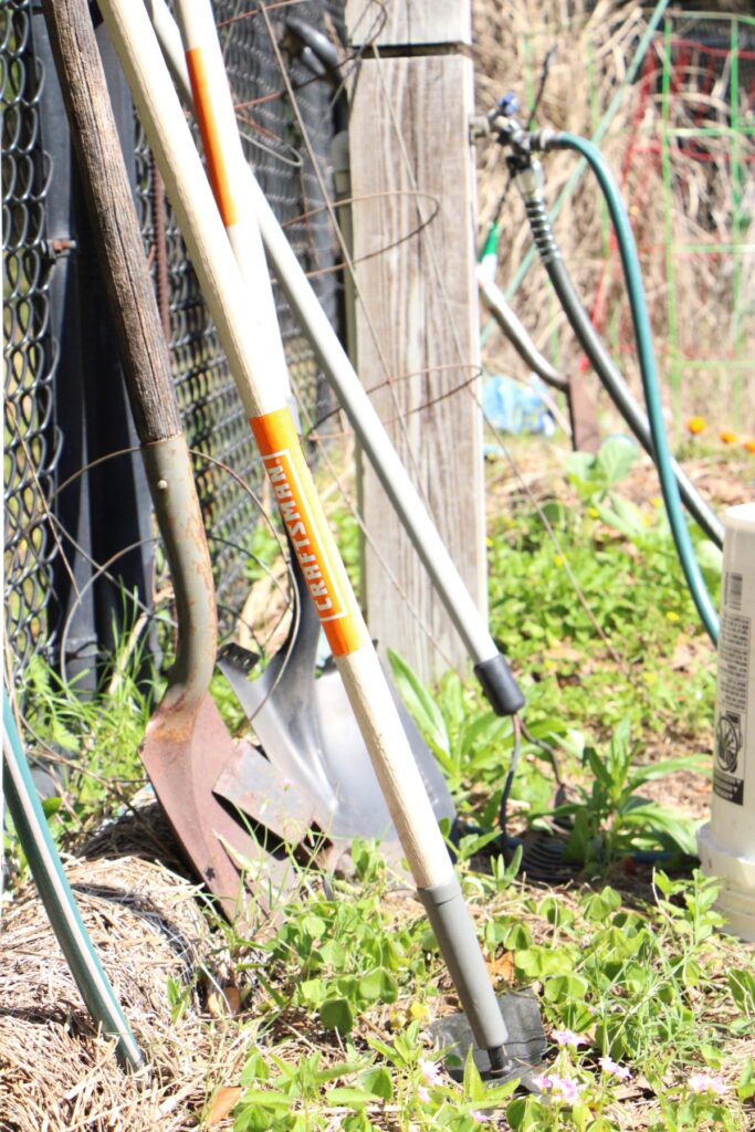 Shovels to use at Green Acres Park community garden line the fence. Photo by Lillian Hamman