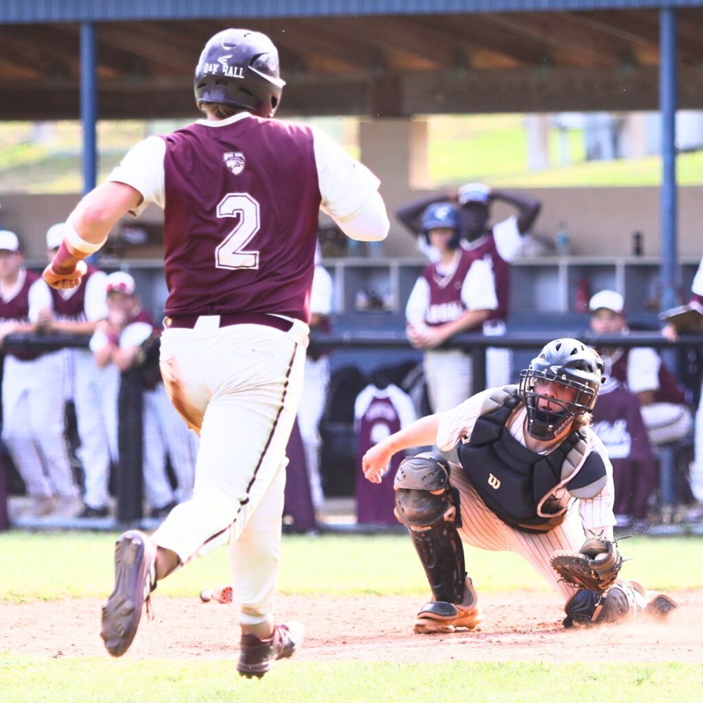 St. Francis Catholic catcher Chris Durstine prepares to tag out Oak Hall's Gavin Jones in the fifth inning in game two of the 1A Regional quarterfinals. Photo by C.J. Gish