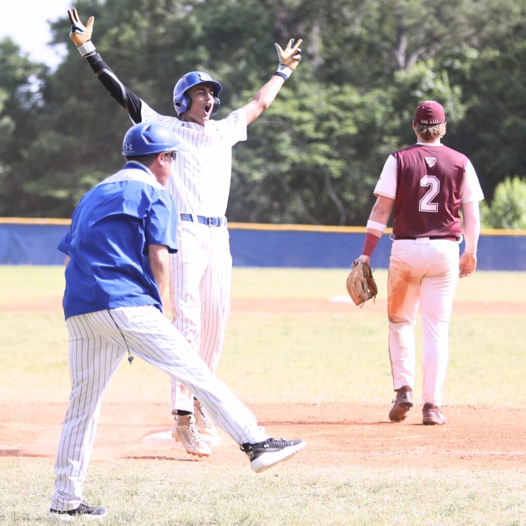 St. Francis Catholic's Colin Kuruppacherry celebrates after hitting a second-inning two-run triple against Oak Hall in the 1A Regional quarterfinals. Photo by C.J. Gish