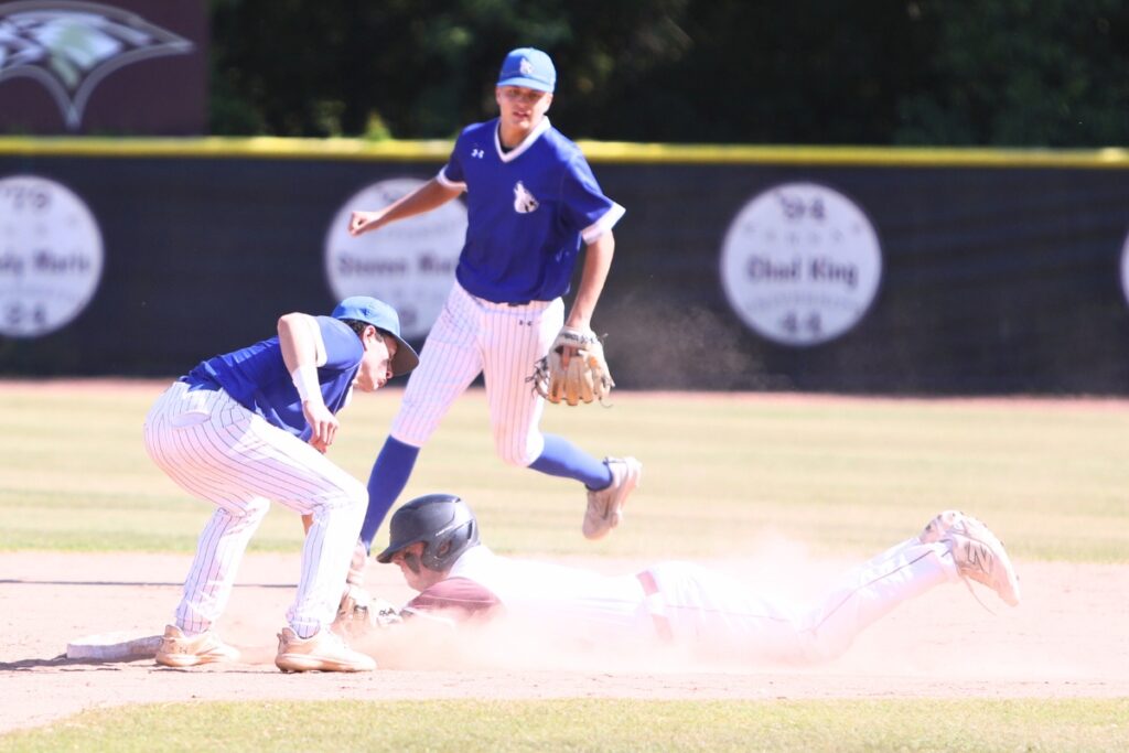St. Francis Catholic's Dylan Diaz tags Oak Hall's Cameron Currier out at second base in the third inning of the Class 1A-District 5 championship game. Photo by C.J. Gish