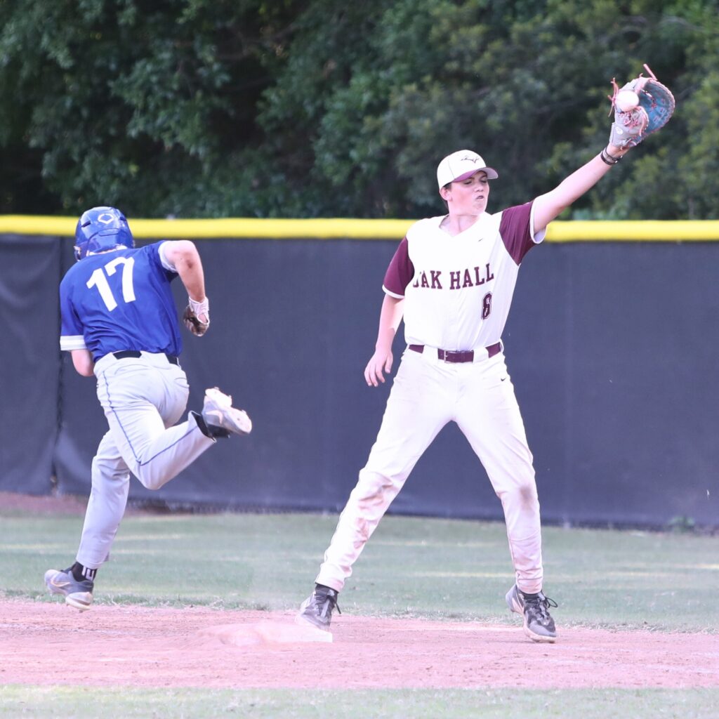 St. Francis Catholic's Sander Williams (17) gets to first base on a sixth inning dropped strike three in game three of the 1A Region 2 Quarterfinals. Photo by C.J. Gish