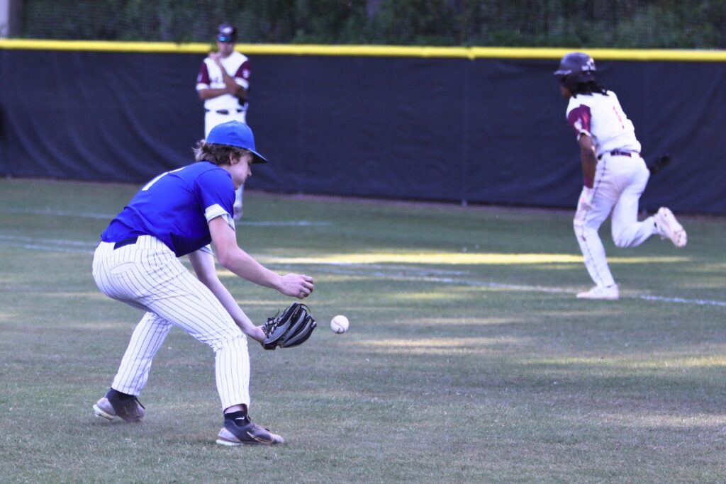 St. Francis Catholic's Sander Williams bobbles the ball on a bunt by Oak Hall's Aaron Akins (1) in the top of the seventh inning in the Class 1A-District 5 championship game.